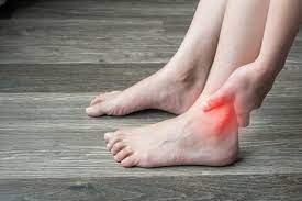 person holding the ankle where ankle instability occurs.